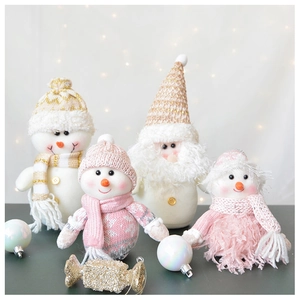 Detail of plush Christmas gnomes with soft pink and white knit textures and festive decor