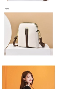 Detail of a cream and brown PU leather crossbody bag featuring dual zippers and metal accents