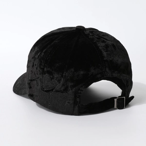 Detailed back view of black velvet baseball cap with adjustable metal buckle strap