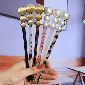 Set of minimalist acetate hair sticks with elegant pearl and matte gold disc accents