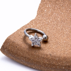 Macro view of silver stainless steel horseshoe ring with crystal star and metal bead detail