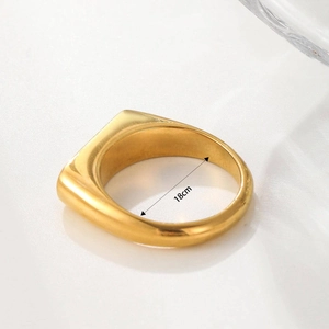Detailed view of gold shell ring showing 18cm inner diameter measurement and polished finish