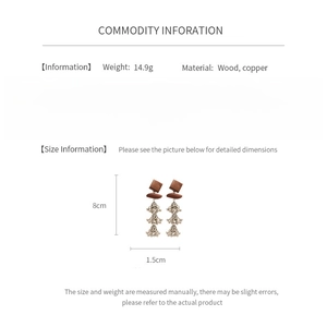 Detail view of bohemian wood and copper tassel earrings showing size and weight specs