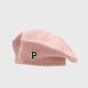 Close-up of the black and white letter P embroidery on a pink knit beret hat