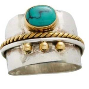 Vintage two-tone spinning ring featuring an oval blue turquoise stone on a silver band