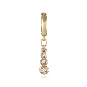 Close-up of 18k gold plated drop earring with four graduated cubic zirconia stones
