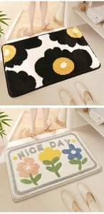 Detail view of floral bath mats featuring high-density absorbent flocking and Nice Day text