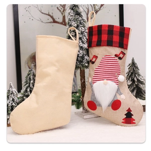 Detail of Christmas stocking featuring gnome design with red and black buffalo plaid cuff