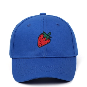 Close-up of vibrant blue baseball cap featuring detailed red strawberry embroidery detail