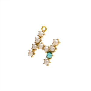 Detail view of golden H letter pendant with white pearls and turquoise bead