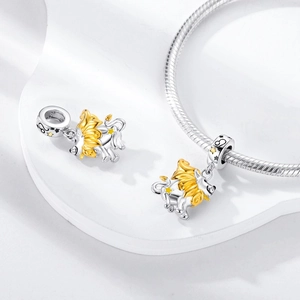Detail of silver and gold Leo zodiac charm bead featuring a stylized lion head design