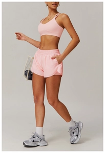 Detailed side view of high-waist pink yoga shorts with pockets and quick-dry fabric