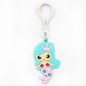 Close-up of a cute cartoon mermaid keychain with a pink crown and white lobster clasp