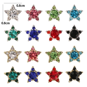 Macro detail of 0.8cm star-shaped metal nail charms with colorful rhinestones in 4x4 grid