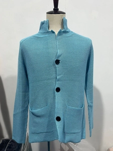 Close-up of blue waffle knit texture and button details on a men's casual cardigan