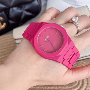 Fashionable rose pink octagon watch with silicone strap shown on wrist with jewelry