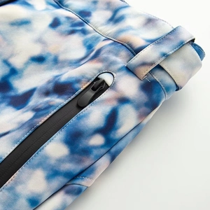 Detail of waterproof zipper and blue gradient print on winter ski jacket fabric