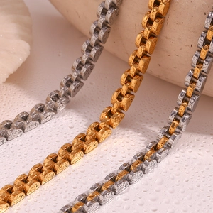 Macro shot of gold and silver watch-style bracelets with water drops showing waterproof metal