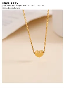 Macro shot of 18K gold-plated heart pendant necklace with elegant minimalist link chain