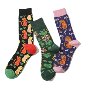 Detailed view of three cotton socks with leopard, tiger, and palm tree prints