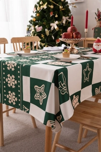 Detail of Christmas tablecloth with green and white checkered stars and glove patterns