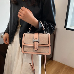 Detail of dust pink floral texture PU leather bag with silver metallic clasp