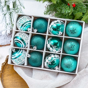 12-pack teal Christmas ornaments in various patterns shown in a gift box arrangement