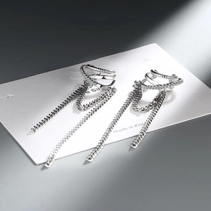 Detail view of long tassel chain earrings with rhinestones and silver finish on card