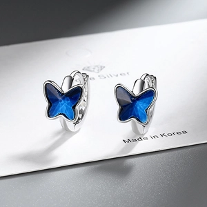 Elegant silver butterfly hoop earrings with blue crystal accents on S925 display card