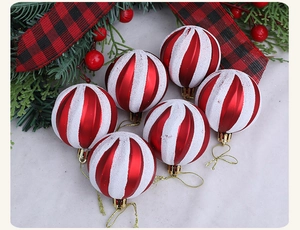 Detail of 6cm red and white striped Christmas balls with glitter and gold hanging strings