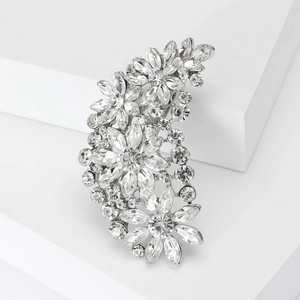 Close-up of vintage flower brooch featuring silver metal and faceted crystal rhinestones