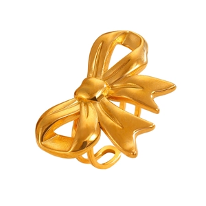 Detailed macro shot of a golden bow ribbon ring with a polished metallic finish
