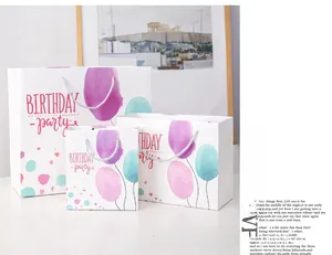 Detail showing three sizes of white paper gift bags with watercolor balloon patterns