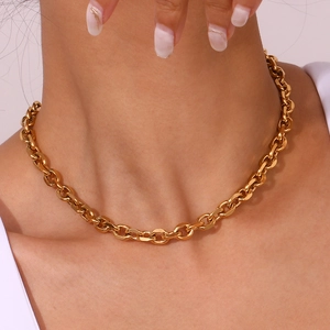 Close-up of chunky gold 18K plated stainless steel chain necklace worn on neck