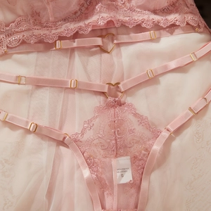 Pink lace lingerie set with heart-shaped gold buckles and adjustable straps