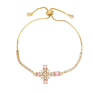 Detail of adjustable gold cross bracelet with pink zircon and white pearls