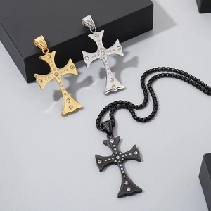 Detail of cross pendants in gold, silver, and black finishes with sparkling crystals