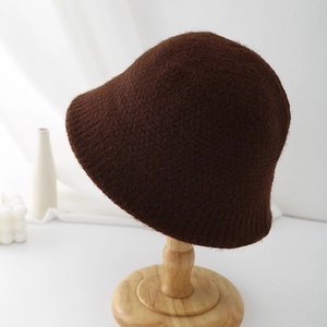 Detailed close-up of dark coffee knit bucket hat with soft plush fuzzy texture