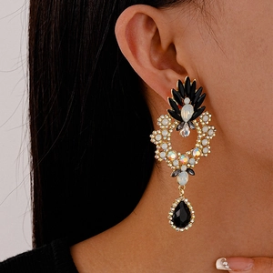 Macro shot of vintage floral drop earrings with black stones and shimmering crystals