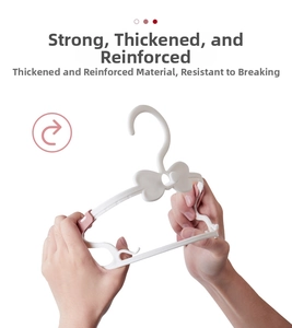 Close-up of white plastic kids hanger showing high flexibility and durable thickened structure