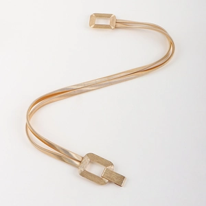 Detailed view of elastic gold metal waist chain with geometric rectangular buckle for dresses