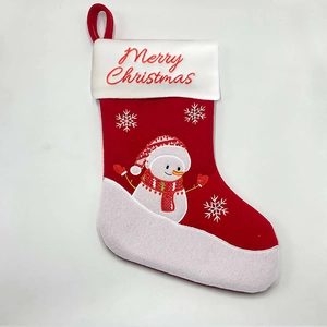 Close-up of red Christmas stocking with white cuff and Merry Christmas embroidery detail