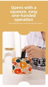 Detail of floral mini storage bag showing the self-closing metal spring mechanism
