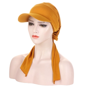 Close-up of ginger yellow hijab cap with visor showing pleated fabric and tie-back details
