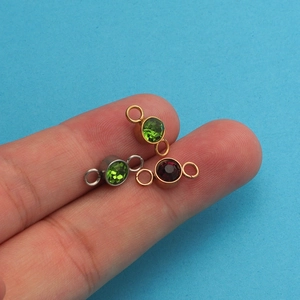Close-up of 6.5mm stainless steel birthstone charms with dual loops for DIY jewelry