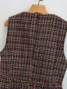 Detailed macro view of the multi-color tweed fabric texture on a round-neck sleeveless top
