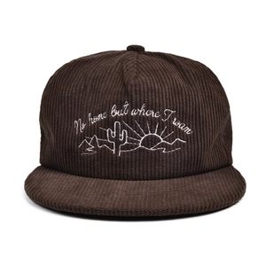 Detail of white desert sun embroidery on dark brown corduroy flat brim baseball cap