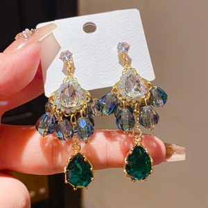 Detail of vintage chandelier earrings with zircon, green drops and 925 silver posts