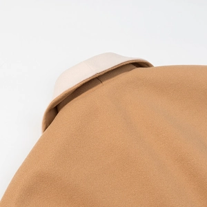 Detail von Kamel und Beige Wollmantel Kragen mit feinen Nähten und gemischter Stoffstruktur
