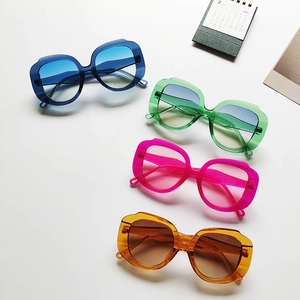 Close-up of oversized irregular sunglasses in four vibrant gradient transparent colors